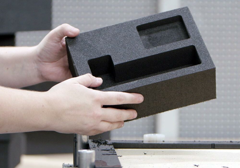 Sustainable foams A person holding a recycled foam insert